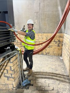 Technician repairing hydraulic hoses